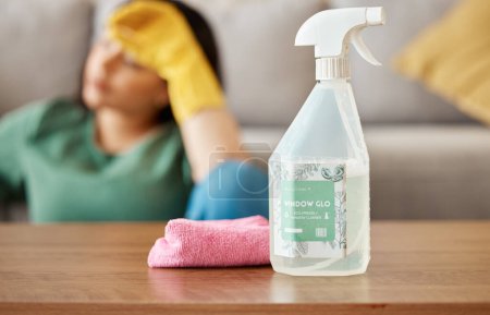 Photo for Cleaning, tired and woman with spray bottle in living room for , housework and maid service. Furniture, housekeeping and exhausted, fatigued and burnout female person with detergent products for dirt. - Royalty Free Image