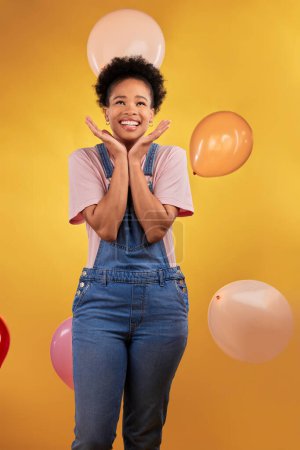 Photo for Balloons, wow and happy woman on birthday, prize or giveaway success, winning and celebration. Party, excited and young african person or gen z winner, competition or sale on yellow studio background. - Royalty Free Image