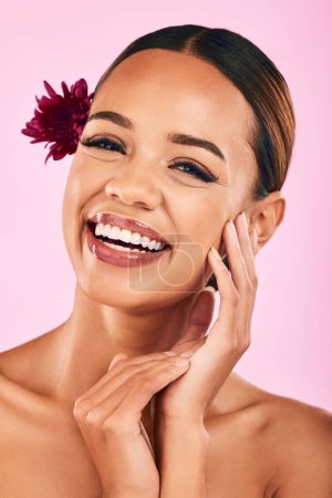 Photo for Natural beauty, flower and portrait of woman with cosmetics, wellness and skin care glow on pink background. Makeup, organic dermatology and model with luxury facial care and healthy spa in studio - Royalty Free Image