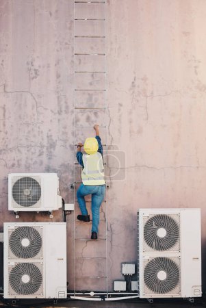 Photo for Technician, ladder and outdoor wall for air conditioner maintenance, construction or site inspection. Engineering person, climbing and safety helmet for ac repair, check and analysis or hvac service. - Royalty Free Image