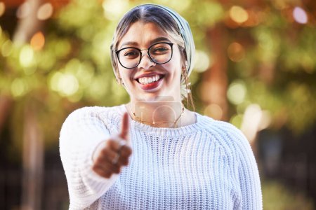 Photo for Young woman, thumbs up in portrait and smile, agreement and yes emoji with like sign and happiness. Deal, support and positive feedback, female person with review and good luck, opinion and vote. - Royalty Free Image