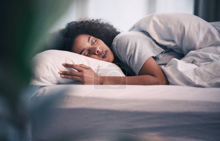 Photo for Sleeping, black woman and bed with morning nap in home with rest feeling calm with peace. House, bedroom and tired female person relax and comfortable on a pillow with blanket dreaming on weekend. - Royalty Free Image