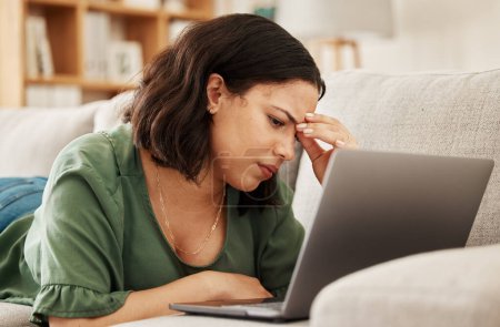 Photo for Woman, home and headache with laptop and remote work stress on a sofa feeling frustrated. House, female person and confused from computer problem with anxiety from online website project on a couch. - Royalty Free Image
