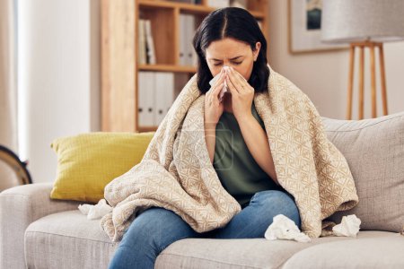 Tissue, blow nose and woman on sofa for home self care with virus, sick and healthcare or allergies. Sinus, flu and person on living room couch with allergy for medical or health and wellness risk.