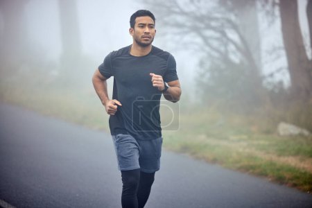 Photo for Man, fitness and running on road in nature for cardio workout, exercise or training outdoors. Fit, active or athlete male person or runner exercising on street asphalt in run for healthy wellness. - Royalty Free Image