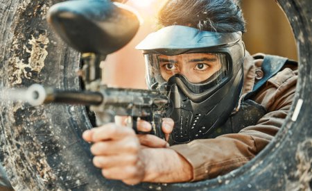 Photo for Paintball, shooting and man in action with gun for tournament, competition and battle in nature. Camouflage, military and male person aim in outdoor arena for training, adventure game or challenge. - Royalty Free Image