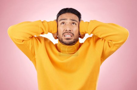 Photo for Headache, stress and asian man in studio with depression, tinnitus or brain fog on pink background. Anxiety, migraine and Japanese guy in crisis, mistake or fail, vertigo or frustrated by noise. - Royalty Free Image