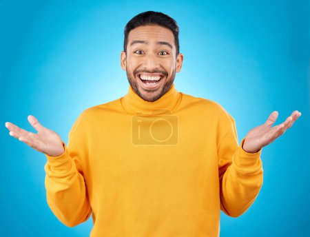 Photo for Wow, portrait and happy man in studio with hands for choice, decision or questions on blue background. Palm, scale and face of male customer excited, asking or why emoji for choosing, option or deal. - Royalty Free Image