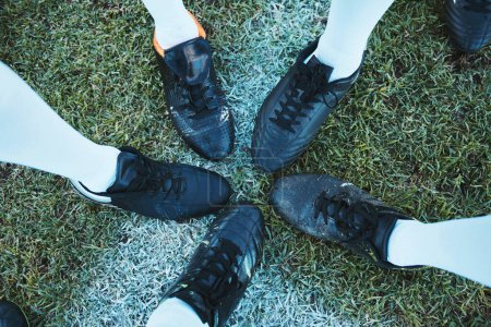 Photo for Soccer, sport shoes and teamwork with people together on a grass field for motivation or competition. Closeup, above and football player or athlete group on a pitch for training, exercise or fitness. - Royalty Free Image