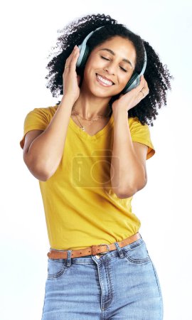 Photo for Music, happy and a woman with headphones in studio streaming audio, sound or radio. Peace, smile and a young African person isolated on a white background listening to fun song to relax or meditate. - Royalty Free Image