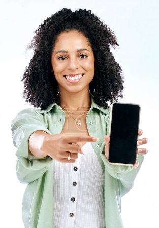 Photo for Screen, mockup or portrait of happy woman with phone on white background on social media or product placement. Pointing, smile or person showing mobile app website or tech mock up space in studio. - Royalty Free Image