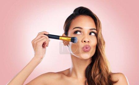 Photo for Beauty, makeup and face of woman with brush on pink background for salon, wellness and luxury. Cosmetology, aesthetic and female person with tools for foundation, cosmetics and glamour in studio. - Royalty Free Image