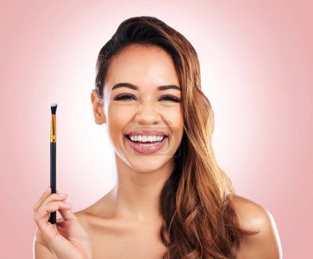 Photo for Beauty, cosmetics and portrait of woman with makeup brush on pink background for salon, wellness and luxury. Cosmetology, aesthetic and female person for foundation, eyeshadow and glamour in studio. - Royalty Free Image
