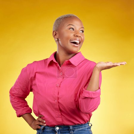Photo for Hand, smile and black woman in studio with sale, news or promotion on yellow background. Happy, deal and African lady show competition, giveaway or contact, info and sign up, platform or how to steps. - Royalty Free Image