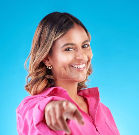 Photo for Pointing finger, smile and portrait of woman in studio to select, advertising or choice. Face of happy model person with hand or emoji for accountability, decision or choosing you on blue background. - Royalty Free Image
