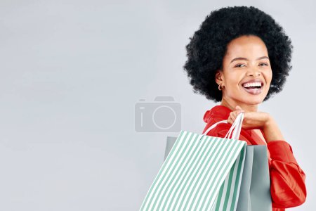 Photo for Shopping bag, portrait and young woman for fashion discount, sale and retail promotion on a white background. Gift, giveaway and happy customer, model or african person with mockup space in studio. - Royalty Free Image