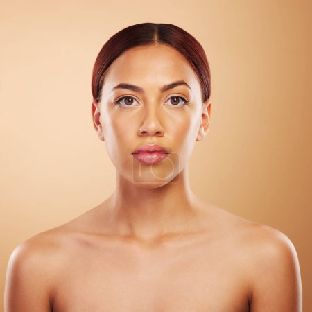 Photo for Portrait, skincare and woman with cosmetics, beauty and wellness against a brown studio background. Face, female person and model with makeup, aesthetic and self care with health, glowing and shine. - Royalty Free Image