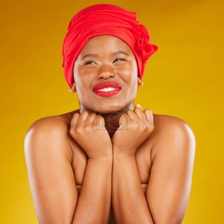 Photo for Beauty, excited and black woman with cosmetic makeup and head wrap with smile isolated in yellow studio background. Happy, skin and skincare by young female person scarf for dermatology or wellness. - Royalty Free Image