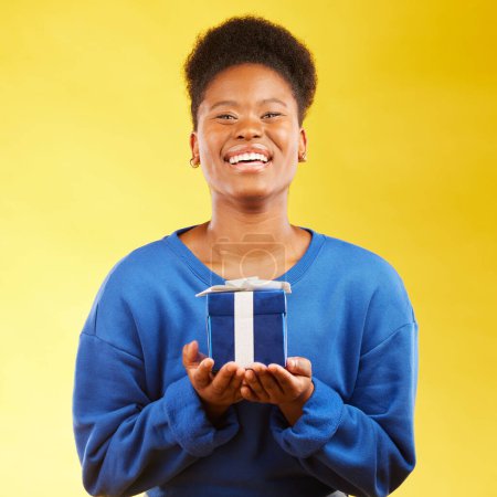 Photo for Gift, birthday and portrait of black woman with a surprise happy isolated in a yellow studio background with a present. Winning, box and excited person to celebrate, party and holiday as a winner. - Royalty Free Image