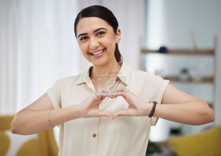 Photo for Portrait, heart and hands of woman in home for care, charity and kindness on valentines day. Happy female person with finger shape for love icon, thank you and emoji in support of freedom in lounge. - Royalty Free Image