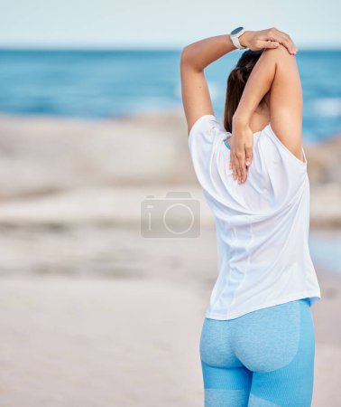 Photo for Woman, fitness and stretching body on beach in workout or getting ready for exercise or outdoor training. Back of sport female person in warm up or healthy wellness on ocean with mockup space. - Royalty Free Image