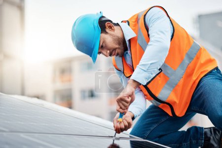 Photo for Solar panels, tool and male engineer on a rooftop doing maintenance or repairs with screwdriver. Renovation, handyman and zoom of an industrial worker working on eco friendly construction on building. - Royalty Free Image