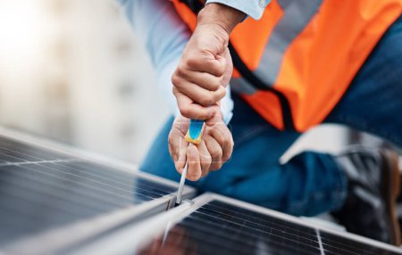 Photo for Solar panels, tool and closeup of male engineer doing maintenance or repairs with screwdriver. Renovation, handyman and zoom of an industrial worker working on eco friendly construction on rooftop - Royalty Free Image