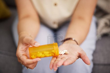 Photo for Woman hands, medicine and bottle of tablet, iron supplements and daily vitamins at home. Closeup, container of pills and prescription drugs in palm of sick person for medical, product and healthcare. - Royalty Free Image