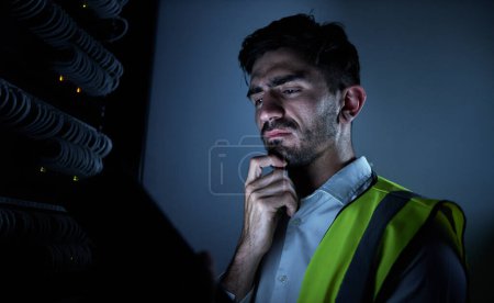 Photo for Engineer man, thinking and dark server room for information technology, maintenance and check app on tablet. IT technician, cyber security and ideas for inspection, analysis and check at data center. - Royalty Free Image