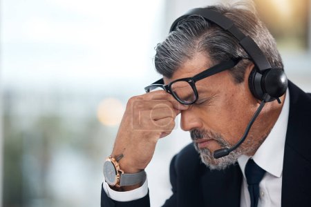 Photo for Stress, sales and man in a call center with a headache from telemarketing or technical support. Sad, fail or a mature customer service employee or boss with a mistake or problem with communication. - Royalty Free Image
