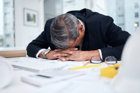 Photo for Tired, exhausted and architect man in an office with a design problem, mistake or deadline for project. Mature male engineer sleeping at desk with fatigue, burnout or crisis in construction industry. - Royalty Free Image