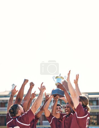 Photo for Rugby, team and winning with trophy, champion and men at stadium with success, celebration and achievement. Male people outdoor, exercise and competition, sports game and cheers with mockup space. - Royalty Free Image