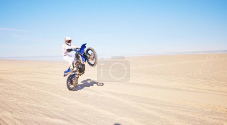 Photo for Desert, motorbike and sports person travel, journey and driving on off road adventure, freedom and balance on bike. Motorcycle, extreme action or athlete driver, racer or rider training on sand dunes. - Royalty Free Image
