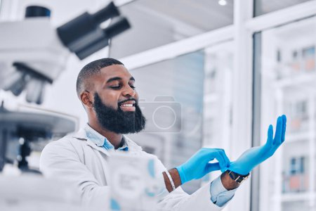 Photo for Scientist, black man and gloves in medical research at laboratory to start science analysis, test or experiment. Happy doctor, ppe or professional in preparation in investigation, assessment or study. - Royalty Free Image