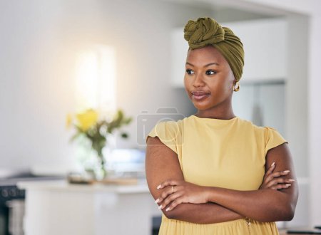 Photo for Thinking, relax and a black woman with arms crossed in a house for a vision, idea or planning. Calm, home and an African girl or person with confidence and motivation in a living room of an apartment. - Royalty Free Image