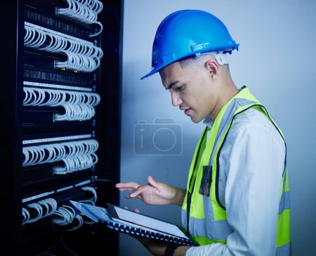 Photo for Man, engineering and tablet for data center maintenance, server room programming or inspection in IT cybersecurity. Electrician or person on typing on digital technology for coding or cables solution. - Royalty Free Image
