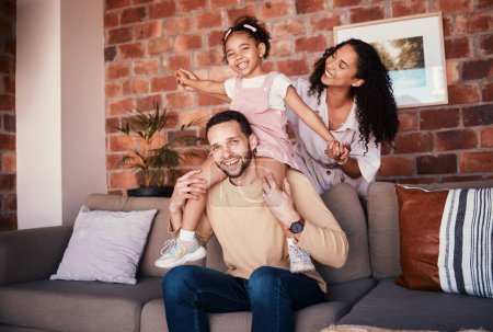 Photo for Family, happy and portrait while playing on a home sofa for fun, bonding and time together. A man, woman and girl kid in a lounge with love, care and happiness for airplane game in Puerto Rico house. - Royalty Free Image
