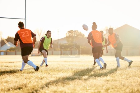 Photo for Rugby, training and men with ball to score goal on field at game, match or practice workout. Sports, fitness and player running to kick at poles on grass with energy and skills in team challenge - Royalty Free Image
