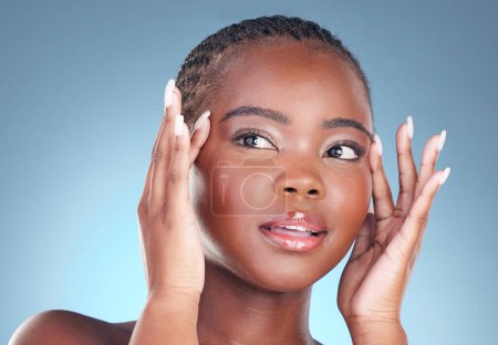 Téléchargez les photos : Visage de femme noire pour cosmétiques, beauté et soins de la peau sur fond bleu pour le bien-être, la santé et le spa. Salon esthétique, dermatologie et personne africaine en studio pour le traitement du visage, maquillage et éclat. - en image libre de droit