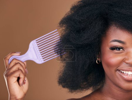 Photo for Portrait, hair and comb with a natural black woman in studio on brown background for cosmetics. Face, smile and haircare with a happy young model brushing her afro after for shampoo treatment. - Royalty Free Image