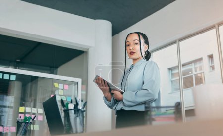 Photo for Low angle portrait of woman in office on tablet, research and sticky note ideas on moodboard for business plan. Internet, confidence and businesswoman on digital app for online review at startup - Royalty Free Image