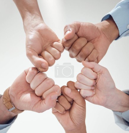 Photo for Fist bump, teamwork or doctors with solidarity in collaboration for healthcare goals together. Clinic closeup, hands or low angle of medical nurses with group support, motivation or mission in circle. - Royalty Free Image