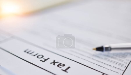 Photo for Taxes paperwork, closeup and finance with accounting, form for income information, audit and contract. Financial paper, money and tax return, government documents and salary earnings with revenue. - Royalty Free Image