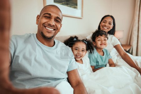 Photo for Relax, selfie and happy family in bed together for social media, profile picture or relax with mom and dad in morning waking up. Parents, kids and smile on face in bedroom for quality time on holiday. - Royalty Free Image