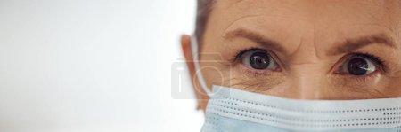 Photo for Doctor, portrait and woman with mask, mockup banner and safety in healthcare in hospital on white background. Ppe, face and eyes of medical professional, rules and compliance working in clinic space - Royalty Free Image