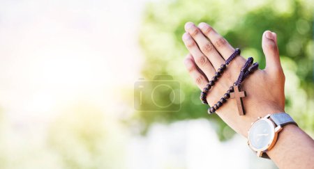 Photo for Faith, hands praying and rosary in garden with mockup, praise and religion with holy mindset. Christian prayer beads, cross and person in worship in nature with hope, spiritual gratitude and space - Royalty Free Image
