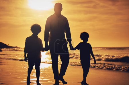 Photo for Silhouette, sunset and father holding hands with children at the beach for walking, bonding and vacation. Dark, care and dad with kids at the ocean for a walk, travel and quality time together. - Royalty Free Image