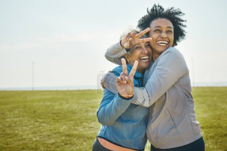 Photo for Senior, women hug and fitness, peace hand sign and portrait with friends, energy and playful outdoor. Happy female people, friendship and cool with sportswear in park, exercise and fun together. - Royalty Free Image