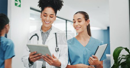 Photo for Women doctors, talking or walking in hospital in teamwork, nurse collaboration or surgery research. Smile, happy or healthcare workers in planning, communication or discussion for medicine treatment. - Royalty Free Image