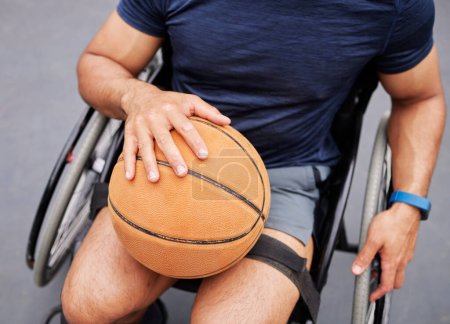 Photo for Wheelchair, basketball and man hand with sports ball outdoor for fitness, training and cardio. Exercise, hobby and top view of male with disability ready for game, workout and fun or active match. - Royalty Free Image